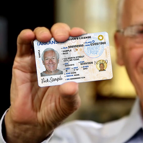 Closeup of man holding Arkansas driver's license